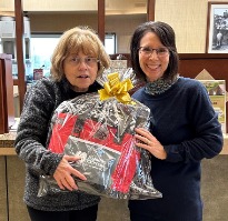 Prize winner holding gift basket.